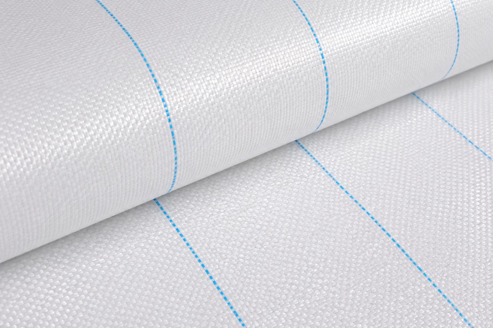 Close-up woven texture of white reflective PE ground cover with blue guide lines